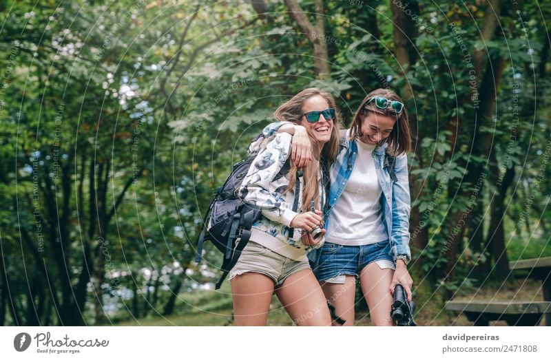 Women friends laughing while walking in forest Lifestyle Joy Happy Relaxation Vacation & Travel Trip Adventure Camping Summer Mountain Hiking Sports Camera