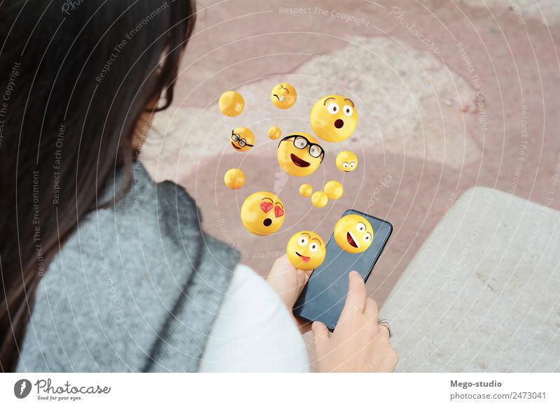 woman using smartphone sending emojis. Lifestyle Happy Face Telephone PDA Screen Technology Internet Human being Woman Adults Hand Funny Modern Smart Emotions