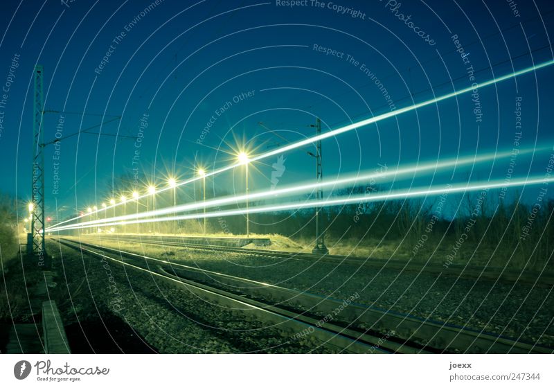 Fast train Sky Beautiful weather Rail transport Platform Railroad tracks Driving Speed Blue Yellow Tracer path Electricity pylon Colour photo Multicoloured