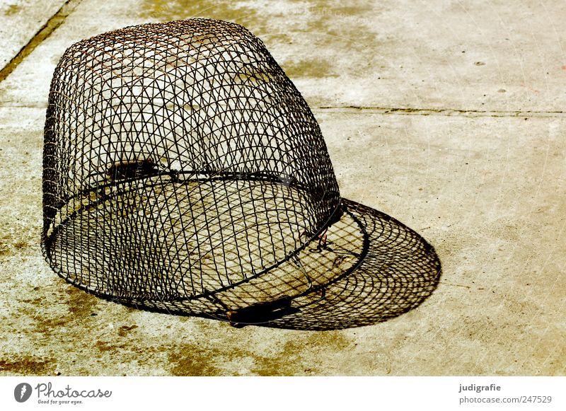 basket Concrete Metal Old Basket Containers and vessels Wire Plaited Colour photo Exterior shot Light Shadow Contrast