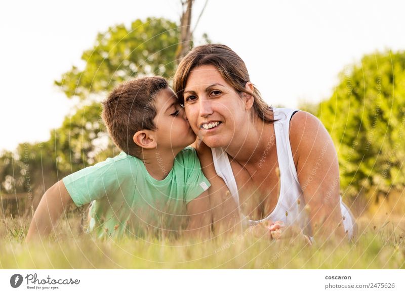 Little boy kissing his mother on a field in summer Lifestyle Joy Happy Beautiful Summer Sun Parenting Child Baby Toddler Boy (child) Woman Adults Parents Mother