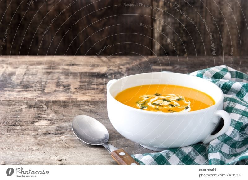 Pumpkin soup in white bowl on wood Food Vegetable Soup Stew Nutrition Eating Organic produce Vegetarian diet Diet Hot drink Bowl Spoon Thanksgiving Hallowe'en