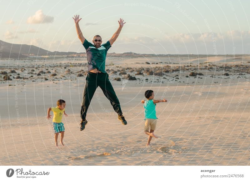 Family jumping on the dunes of Corralejo Joy Happy Relaxation Playing Vacation & Travel Island Child Human being Masculine Boy (child) Young man