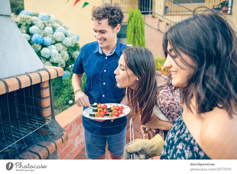 Group of friends cooking in a summer barbecue Vegetable Lunch Alcoholic drinks Beer Plate Bottle Lifestyle Joy Happy Leisure and hobbies Summer Garden To talk