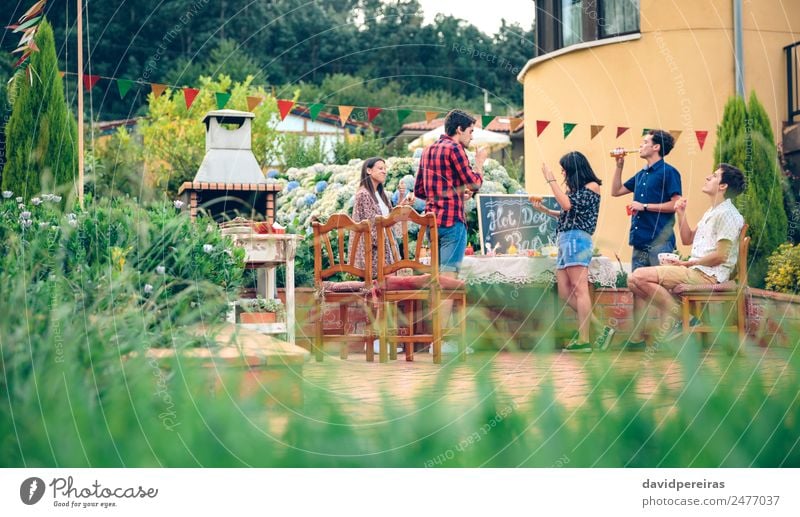 Friends enjoying in outdoors summer barbecue Meat Sausage Lunch Alcoholic drinks Beer Bottle Lifestyle Joy Happy Leisure and hobbies Summer Garden Table To talk