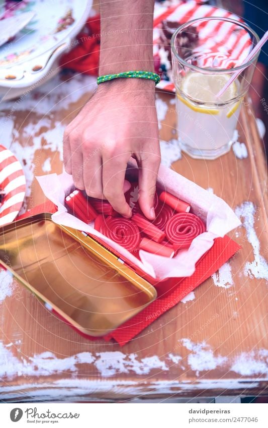 Male hand picking candy of box in a summer party Dessert Lunch Lemonade Plate Lifestyle Joy Happy Leisure and hobbies Summer Feasts & Celebrations Man Adults