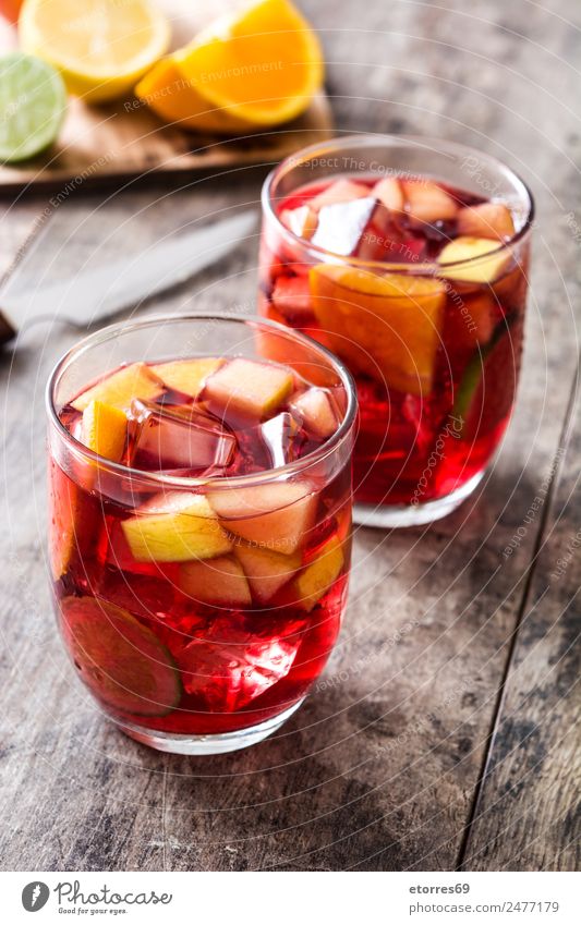 Sangria drink in glass on wood sangria Beverage Drinking Summer Alcoholic drinks Red Fruit Spanish Orange Apple Lemon Lime Delicious Refreshment Cold Ice