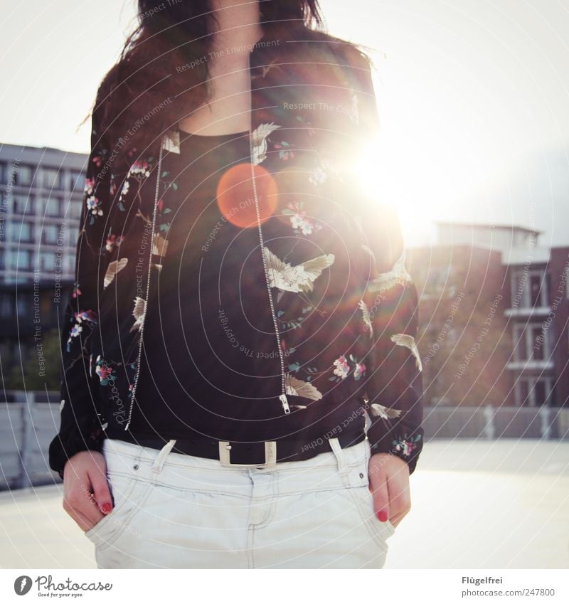 O Feminine Young woman Youth (Young adults) Woman Adults 18 - 30 years Stand Bird Jacket Bag Lens flare Parking garage Sky House (Residential Structure) Sunset