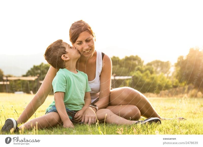 Little boy kissing his mother on a field in summer Lifestyle Vacation & Travel Summer Mother's Day Human being Feminine Child Baby Toddler Boy (child) Woman