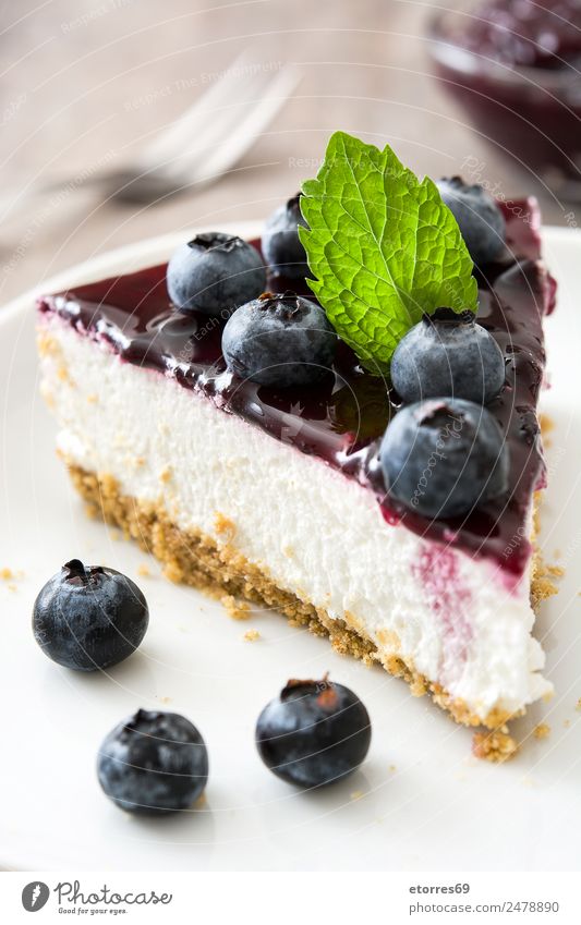 Piece of blueberry cheesecake on wooden table Cheese Cheese slice Blueberry Baked goods Cake Dessert Fruit Sweet Candy Food Healthy Eating Food photograph