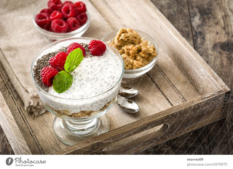 Chia yogurt with raspberries in a glass cup on wood chia Yoghurt Raspberry Dairy Fruit Healthy Eating Vegan diet Vegetarian diet superfood Natural Delicious