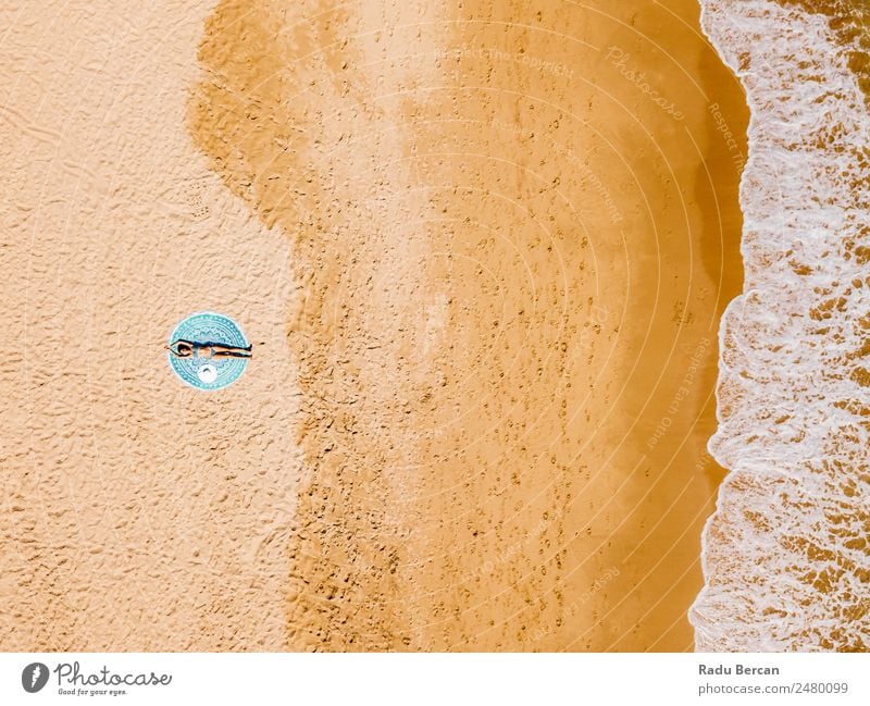 Top Aerial Drone View Of Woman In Swimsuit Bikini Relaxing And Sunbathing On Round Turquoise Beach Towel Near The Ocean Vantage point Aircraft Summer