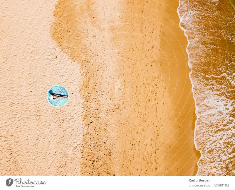 Top Aerial Drone View Of Woman In Swimsuit Bikini Relaxing And Sunbathing On Round Turquoise Beach Towel Near The Ocean Vantage point Aircraft Summer