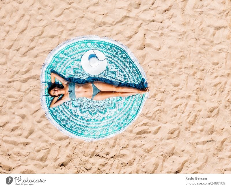 Top Aerial Drone View Of Woman In Swimsuit Bikini Relaxing And Sunbathing On Round Turquoise Beach Towel Near The Ocean Vantage point Aircraft Summer