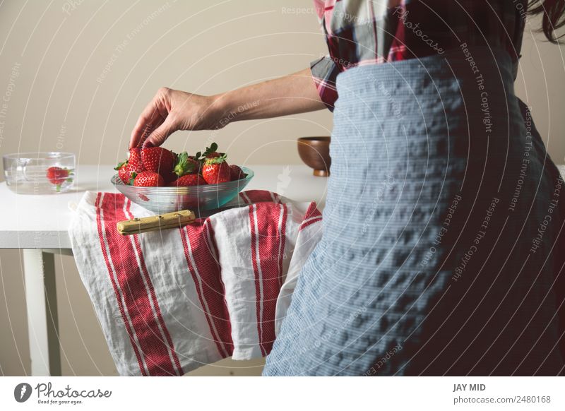 woman picking strawberries, a glass bowl Food Fruit Nutrition Eating Human being Woman Adults Hand 1 30 - 45 years Fragrance Colour "woman; strawberry; bowl