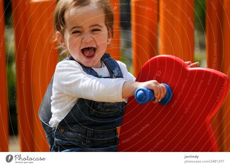 Happy little girl playing in a urban playground. Lifestyle Joy Beautiful Leisure and hobbies Playing Summer Climbing Mountaineering Child Human being Baby Girl