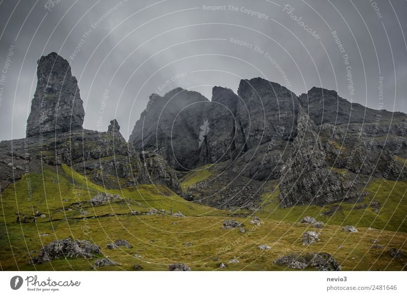 Old Man of Storr on the Isle of Skye in Scotland Landscape Storm clouds Autumn Climate Weather Bad weather Fog Rain Grass Foliage plant Mountain Peak Island