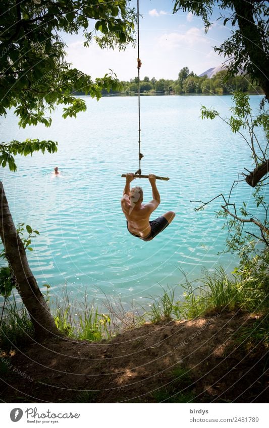 Swimming fun at quarry pond, young adults swing into the water bathing fun Leisure and hobbies Holiday at home Adventure Summer vacation Lake Baggersee