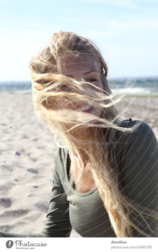 Young woman at the stand blond hair blows around her pretty Hair and hairstyles Well-being Trip Youth (Young adults) 18 - 30 years Adults Landscape Summer