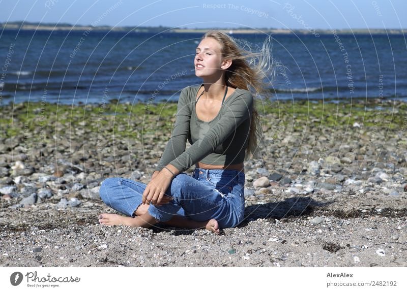 Young woman on the beach in the sun Lifestyle Happy pretty Well-being Summer Summer vacation Sun Sunbathing Beach Ocean Waves Youth (Young adults) 18 - 30 years