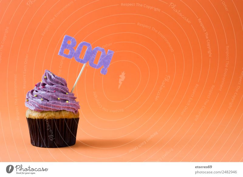 Halloween cupcake on orange background Food Cake Dessert Candy Nutrition Hallowe'en Natural Violet Orange Cupcake Food photograph Sweet Cream Decoration Muffin