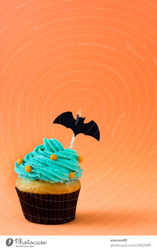 Halloween cupcake on orange background Food Cake Dessert Candy Nutrition Hallowe'en Green Orange Cupcake Baked goods Decoration Party Festive Vacation & Travel