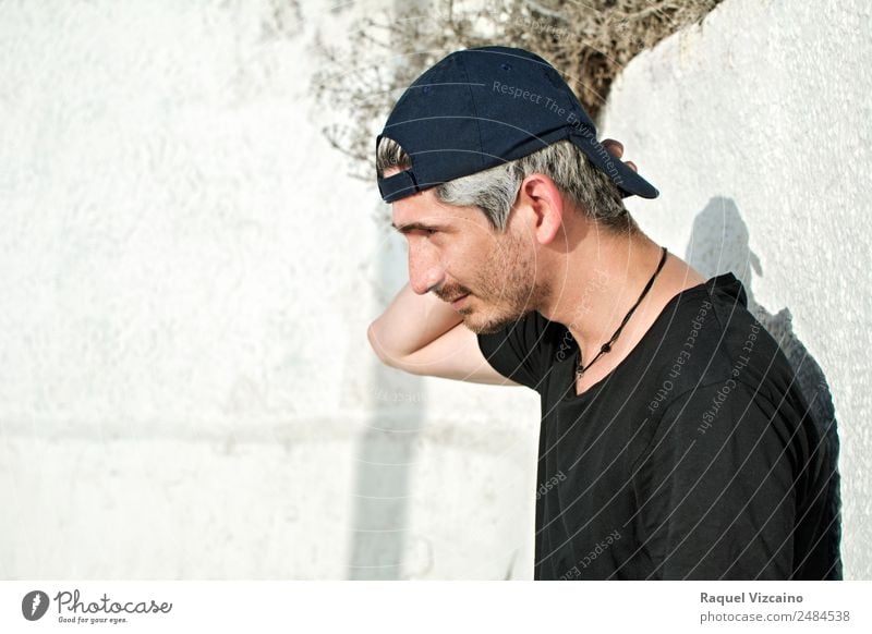 urban boy, with black cap. Masculine Young man Youth (Young adults) Head 1 Human being 30 - 45 years Adults T-shirt Cap White-haired Think Looking Town Black