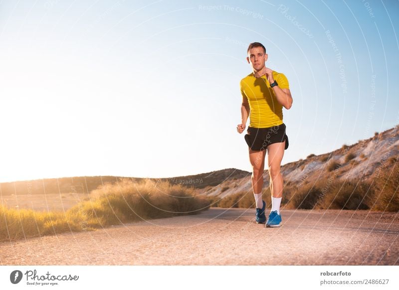 Young man running with greenish yellow shirt Lifestyle Sun Sports Jogging Human being Man Adults Park Bridge Movement Fitness Athletic Speed White young healthy