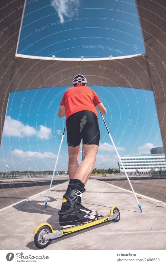 A young man cross-country skiing with roller ski Lifestyle Style Leisure and hobbies Summer Mountain Sports Skiing Skis Man Adults Nature Landscape Park Street