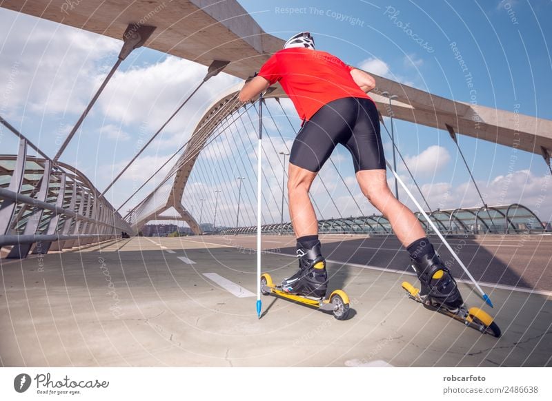 A young man cross-country skiing with roller ski Lifestyle Style Leisure and hobbies Summer Mountain Sports Skiing Skis Man Adults Nature Landscape Park Street