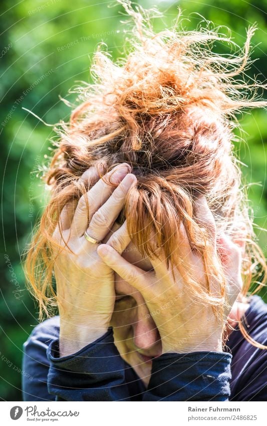 a desperate woman holding her hands in front of her face Human being Feminine Woman Adults Female senior Face 1 45 - 60 years Think Emotions Moody