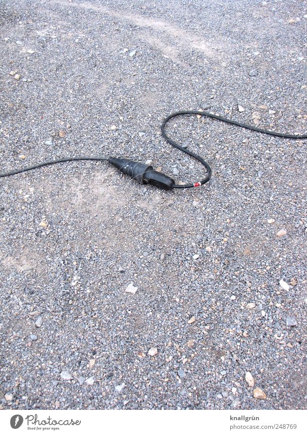 Strong connection Cable Lie Gray Black Power Energy Contact extension cord plug device rubber cable Gravel Electricity Colour photo Subdued colour Exterior shot