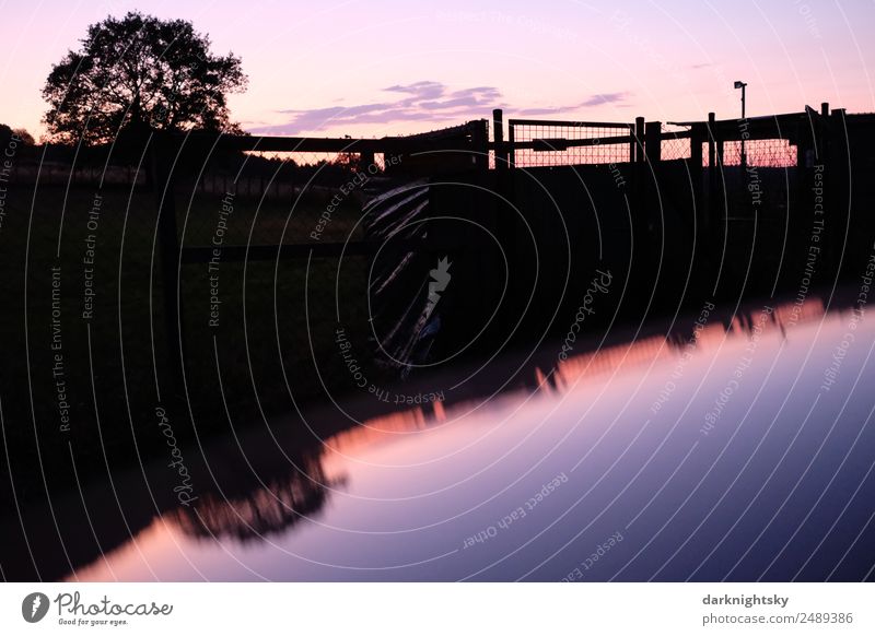 Panorama of an evening landscape with reflection Motorsports Hiking Nature Landscape Water Fluid Glittering Infinity Retro Round Clean Warmth Blue Violet Orange