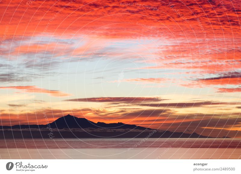 Sunrise in the sea for background. Ocean Nature Landscape Sky Clouds Horizon Coast Skyline Bright Gold Red Colour Canaries Spain Teide Tenerife calm Dramatic