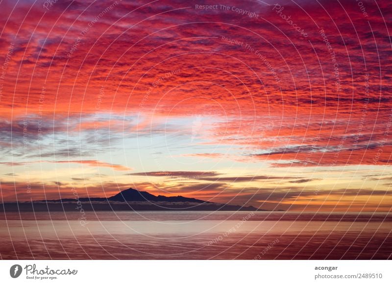 Sunrise in the sea for background. Ocean Nature Landscape Sky Clouds Horizon Coast Skyline Bright Multicoloured Gold Red Colour Canaries Spain Teide Tenerife