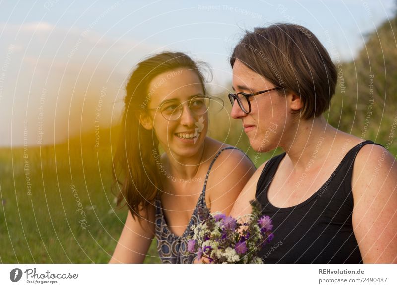 Two young women sitting on a meadow 18 - 30 years Woman Nature Love Sister Happy Together Summer Joie de vivre (Vitality) Relaxation Friendship Attachment