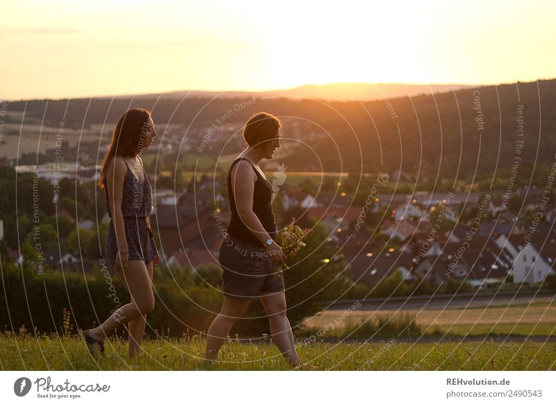 2 women walking in the evening light Leisure and hobbies Trip Summer Sun Human being Feminine Young woman Youth (Young adults) Brothers and sisters Sister