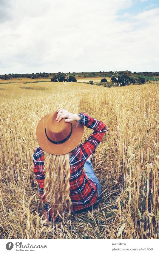 Back view of a young woman in a wheat field Grain Wheat Lifestyle Style Wellness Well-being Relaxation Vacation & Travel Adventure Freedom Summer