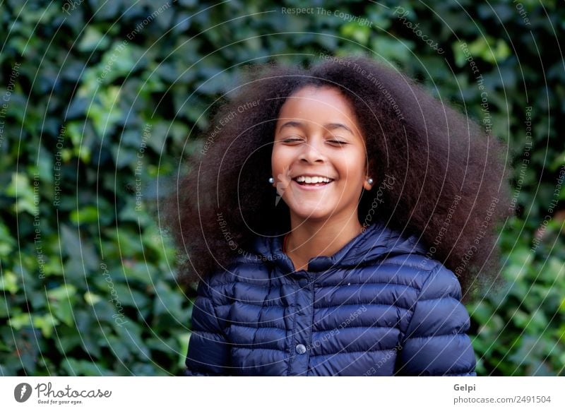 Pretty girl with long afro hair Happy Beautiful Face Winter Garden Child Human being Woman Adults Infancy Park Coat Brunette Afro Smiling Happiness Long Cute