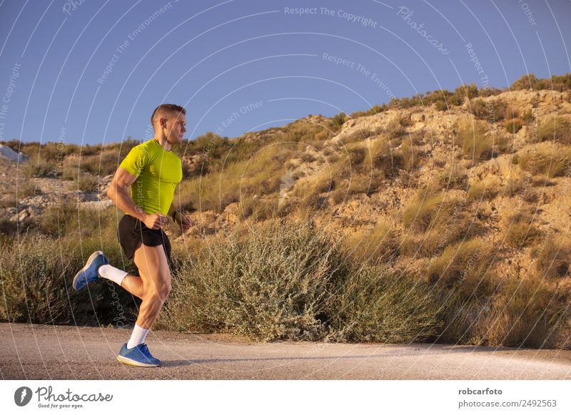 Young man running with greenish yellow shirt Lifestyle Sun Sports Jogging Human being Man Adults Park Bridge Movement Fitness Athletic Speed White young healthy