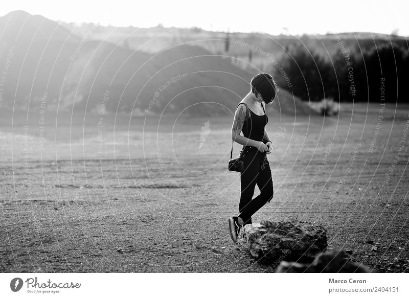 professional photographer, taking pictures of a beautiful nature surrounding her, warm sunny day, Young woman attractive background black black and white