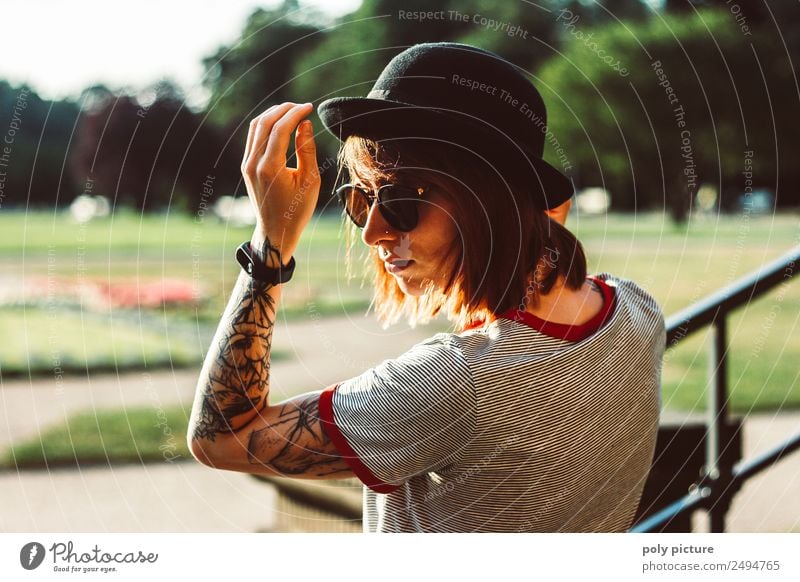 [LS107] - Young woman with sunglasses, hat and tattoo in the park Lifestyle Style Youth (Young adults) Adults Head Arm Hand 13 - 18 years 18 - 30 years Summer