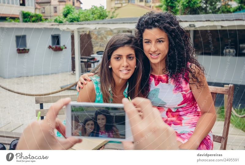 Man hands taking photo to two happy women outdoors Lifestyle Happy Leisure and hobbies Vacation & Travel Summer Telephone PDA Screen Camera Technology