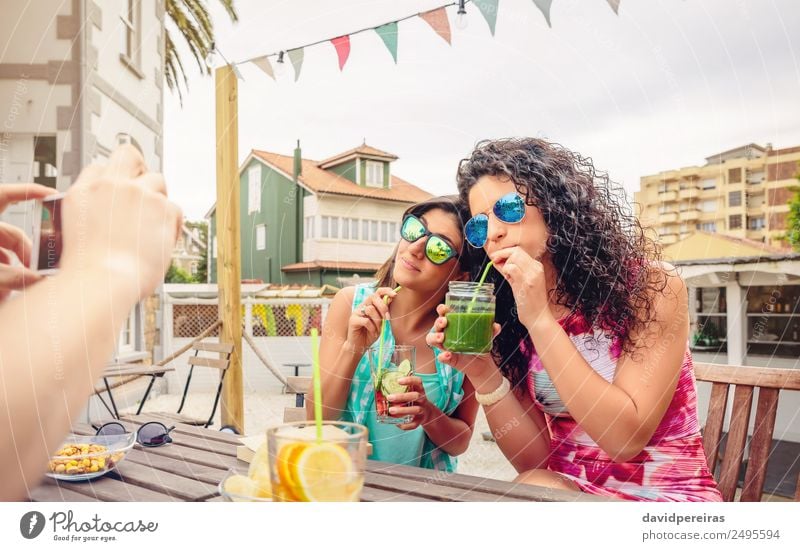 Young women couple drinking healthy drinks outdoors Vegetable Fruit Beverage Drinking Lifestyle Joy Happy Beautiful Leisure and hobbies Summer Garden