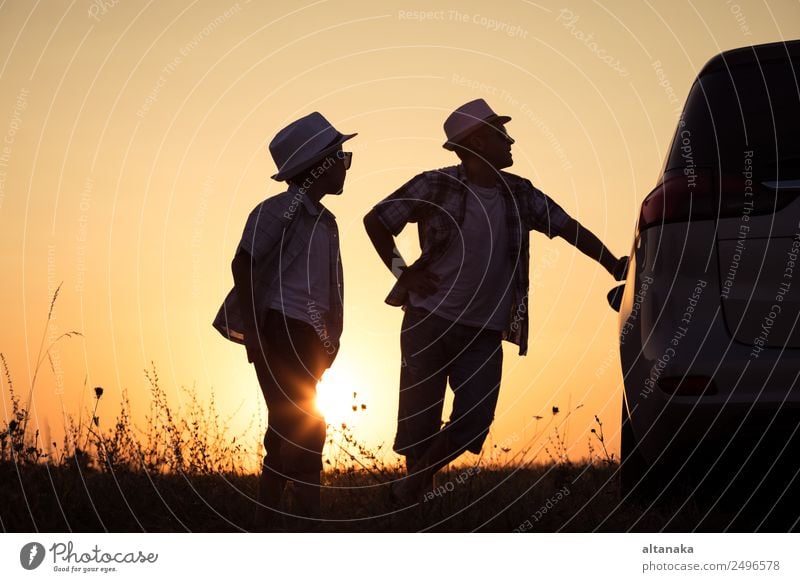 Father and son playing in the park at the sunset time. People having fun outdoors. Concept of summer vacation and friendly family. Lifestyle Joy Happy