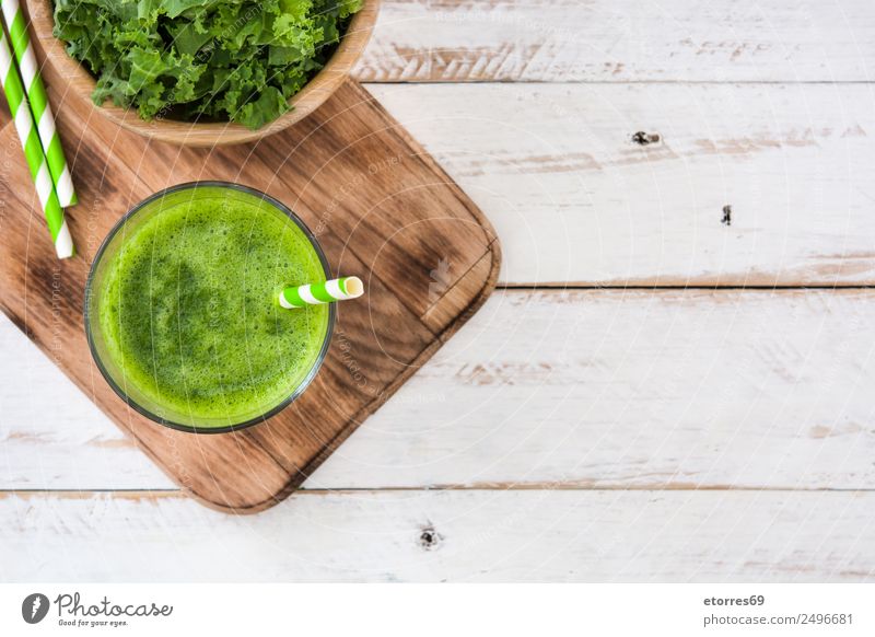 Kale smoothie in glass on white wooden background. Milkshake Beverage Drinking Green Detox Healthy Healthy Eating Vitamin superfood Vegan diet Vegetarian diet