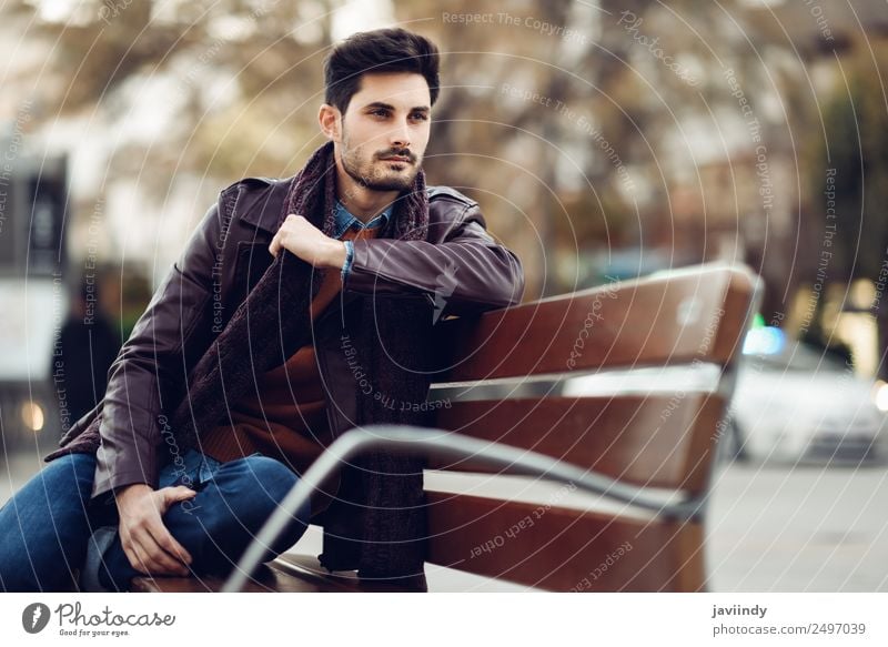 Thoughtful young man sitting on an urban bench Lifestyle Style Beautiful Hair and hairstyles Human being Masculine Young man Youth (Young adults) Man Adults 1