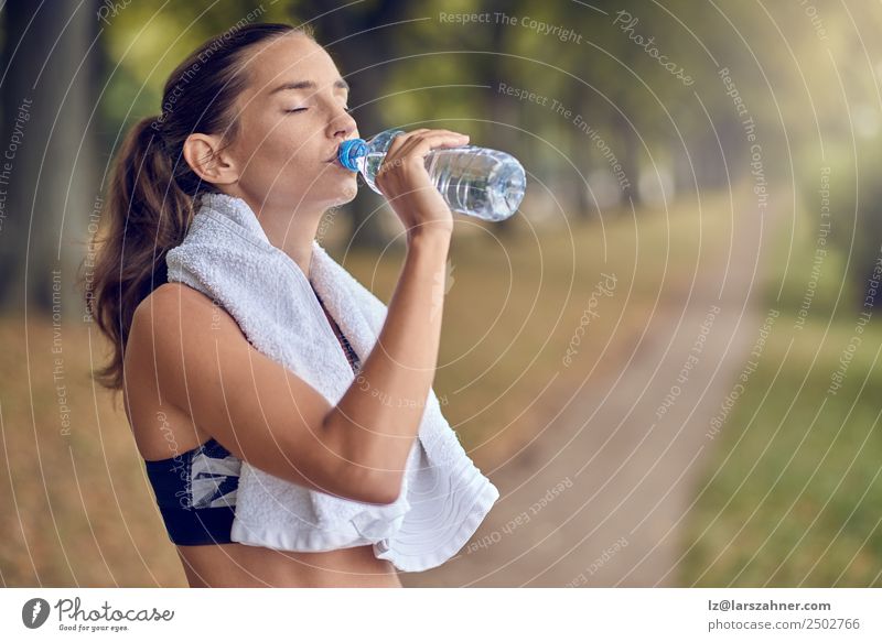 Fit sporty woman drinking water from a bottle Bottle Sports Woman Adults 1 Human being 18 - 30 years Youth (Young adults) Park Fitness Athletic training young