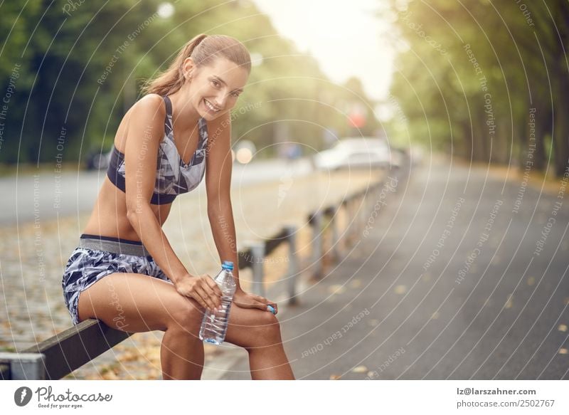 Happy fit woman taking a break from jogging Drinking Lifestyle Summer Sports Jogging Woman Adults 1 Human being 18 - 30 years Youth (Young adults) Warmth Street