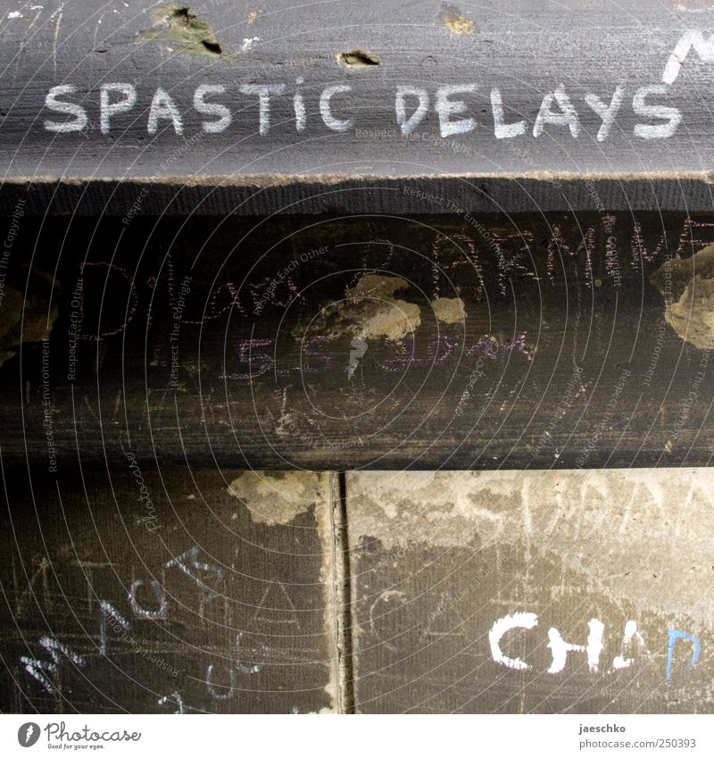 Spastic delays Wall (barrier) Wall (building) Stone Concrete Sign Characters Graffiti Rebellious Trashy Scribbles Daub Whimsical spastic Colour photo